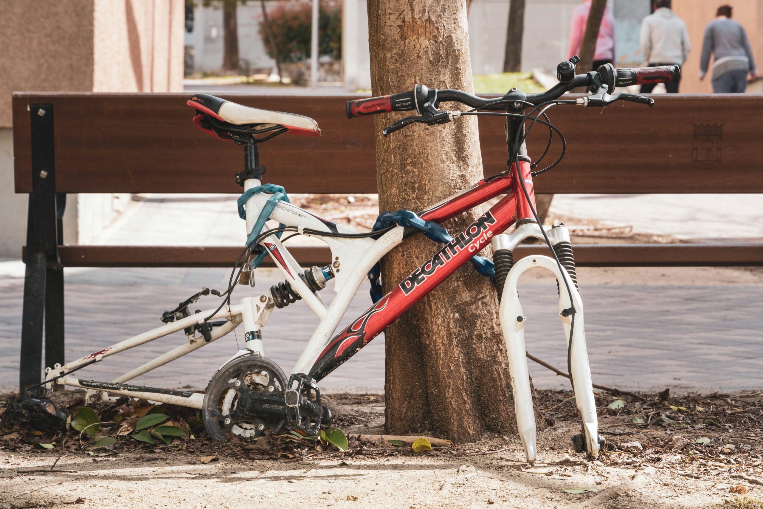 Red and white bicycle with its tires stolen