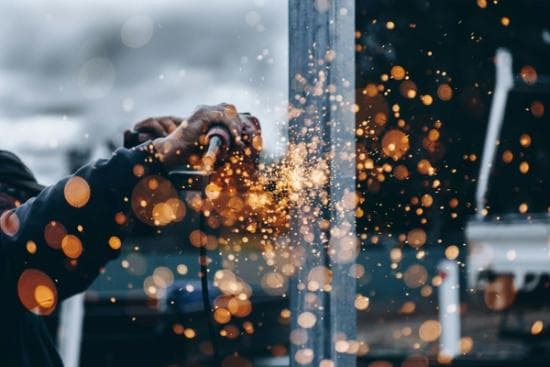 Contractor holding tool with sparks flying