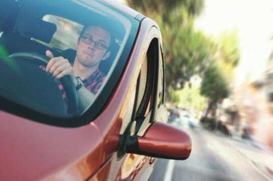 person driving red vehicle