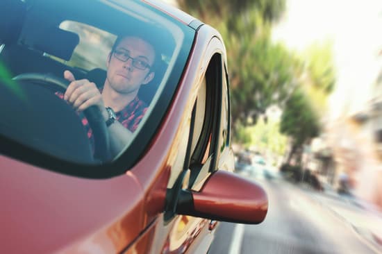person driving red vehicle