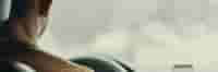 Man Driving Vehicle with Phone in View