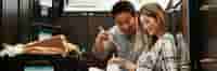 Couple eating take out in new home