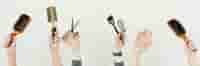 multiple hands holding brushes and scissors