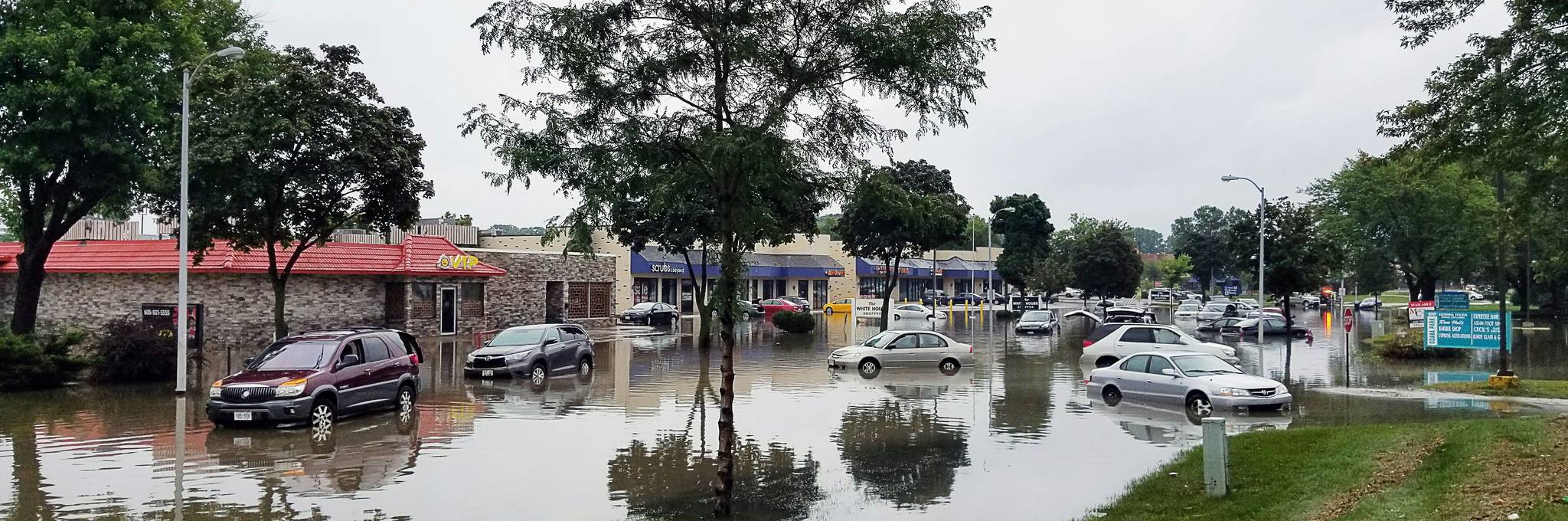 Flooded city streets with submerged vehicles