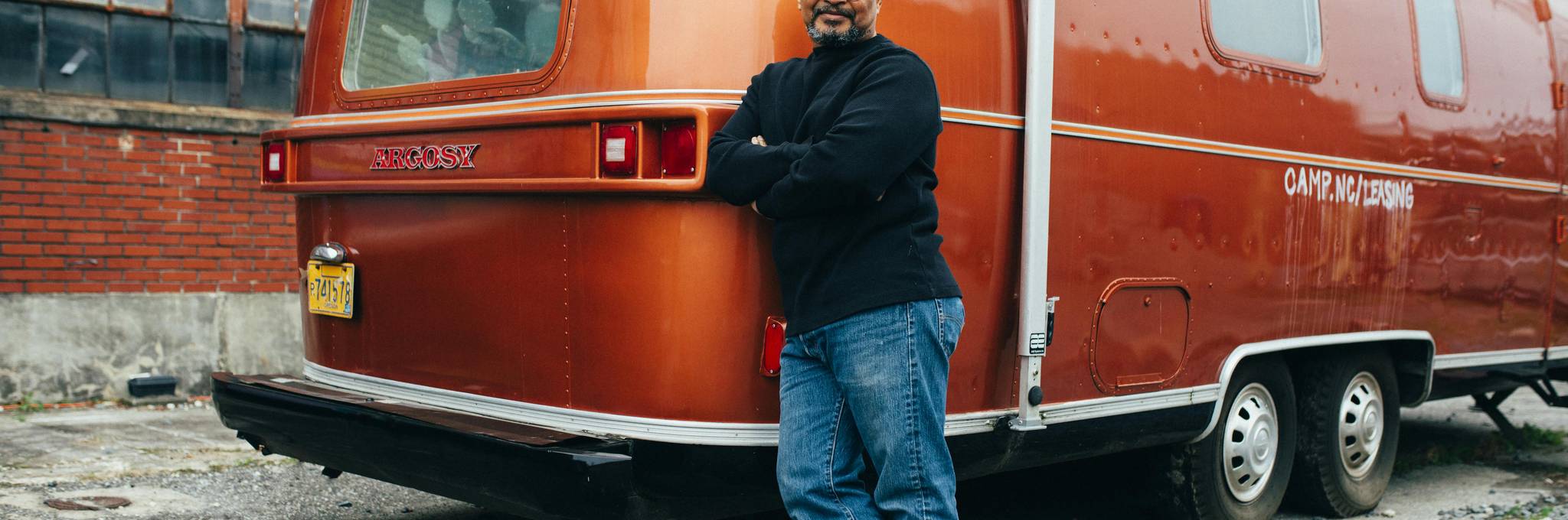 happy man standing by rv