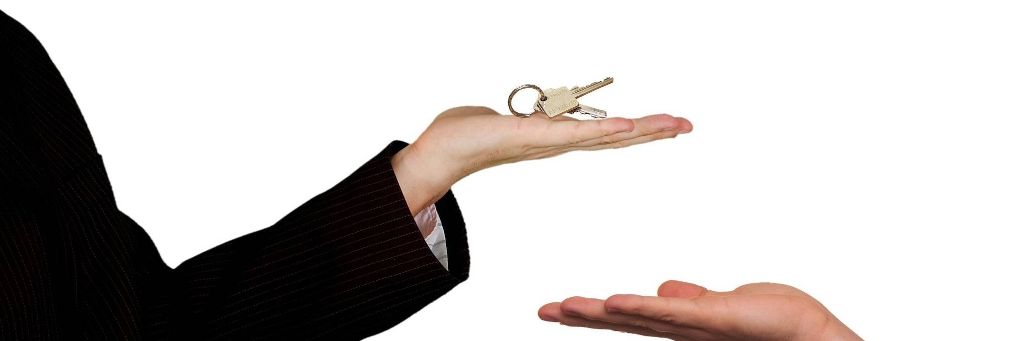 real estate agent handing keys