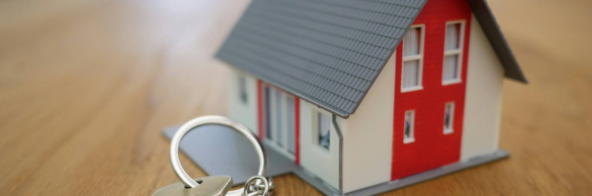 Miniature House and Keys on a table