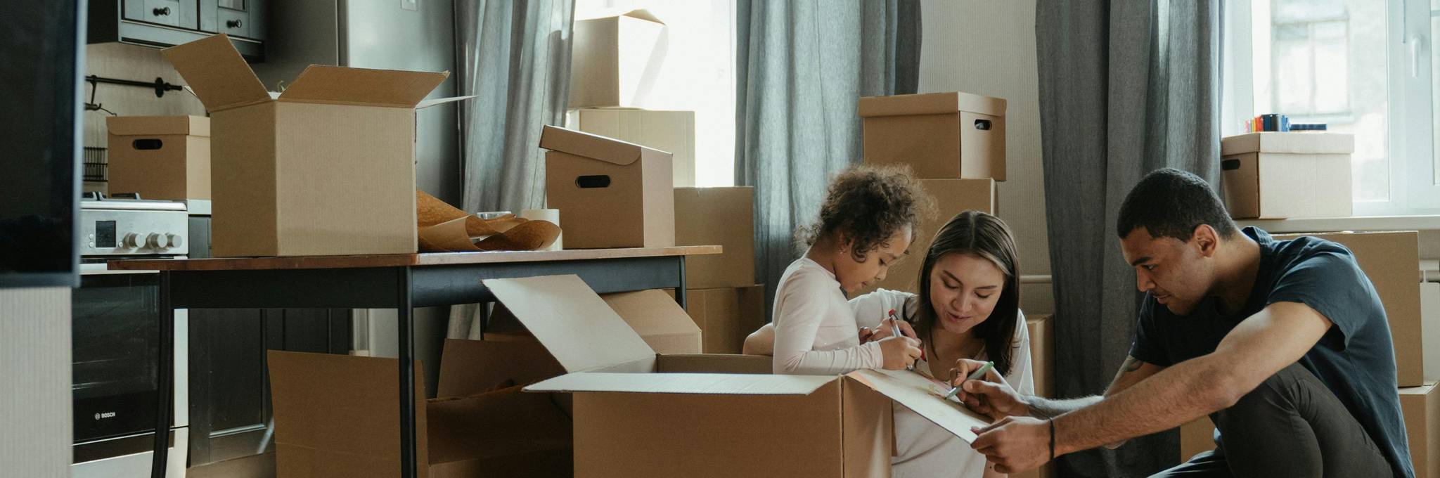 family unpacking in new home