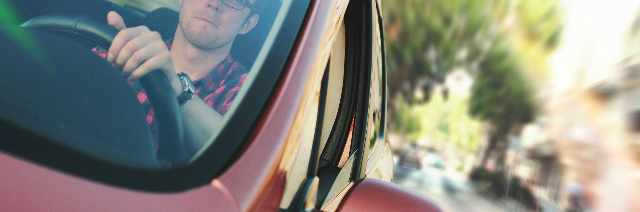 person driving red vehicle